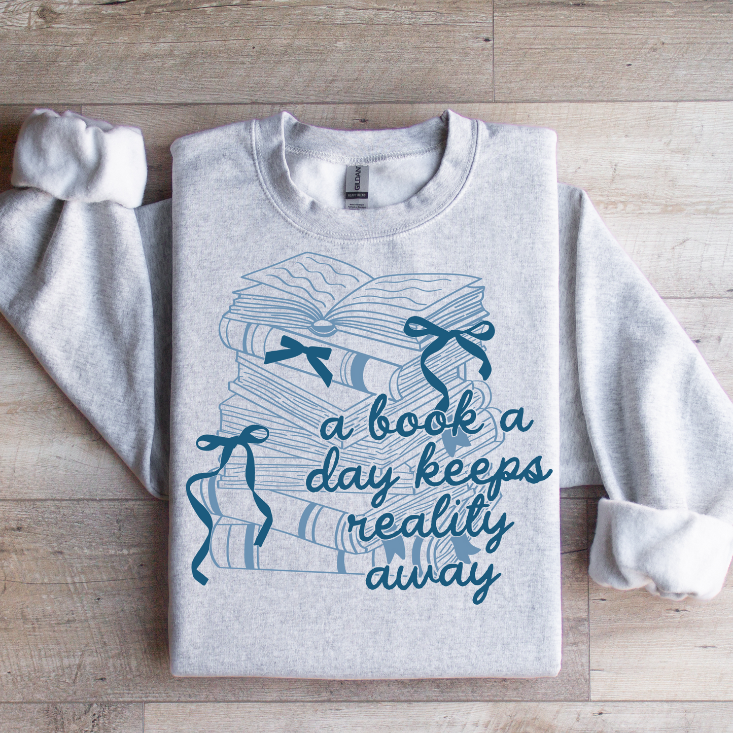 A Book A Day Keeps Reality Away Graphic Tee