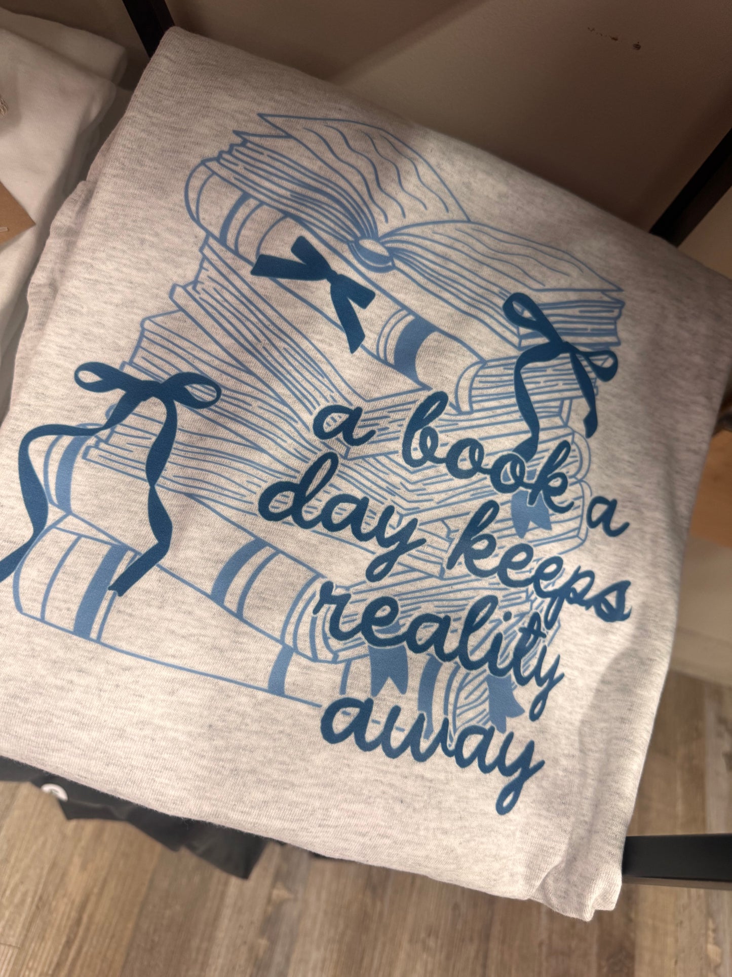 Graphic Tee Sale - Long Sleeve A Book a Day Keeps Reality Away